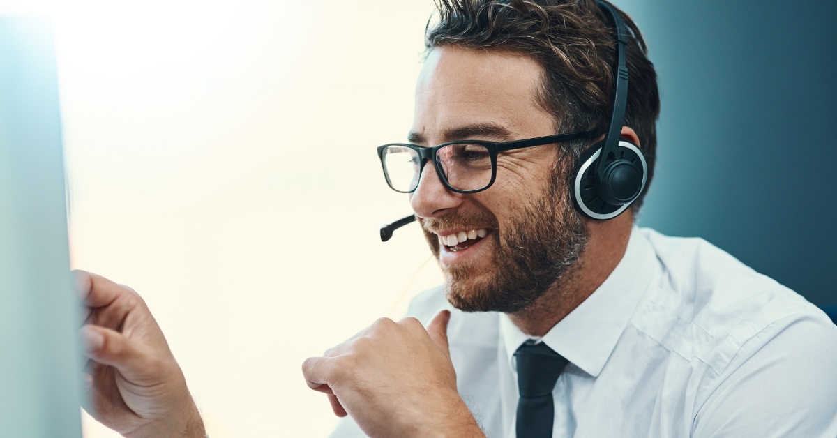 Man in a call centre smiling