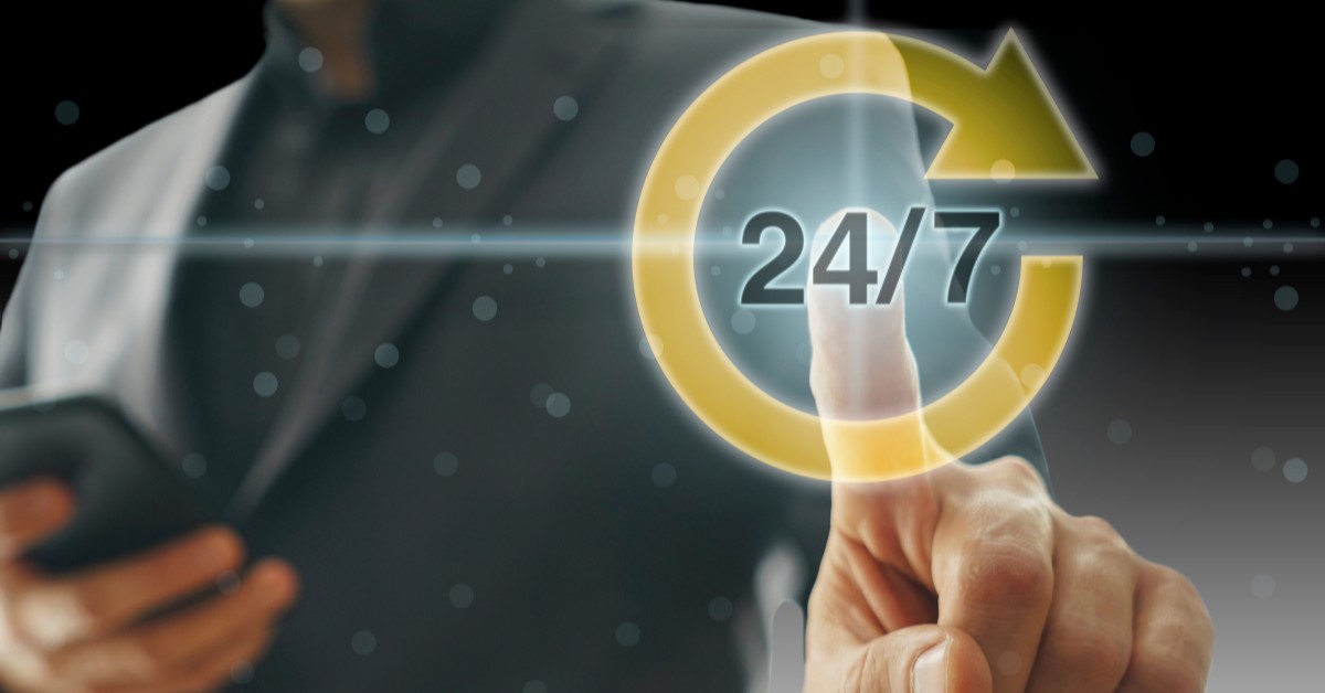 Man in a suit with a 24/7 sign