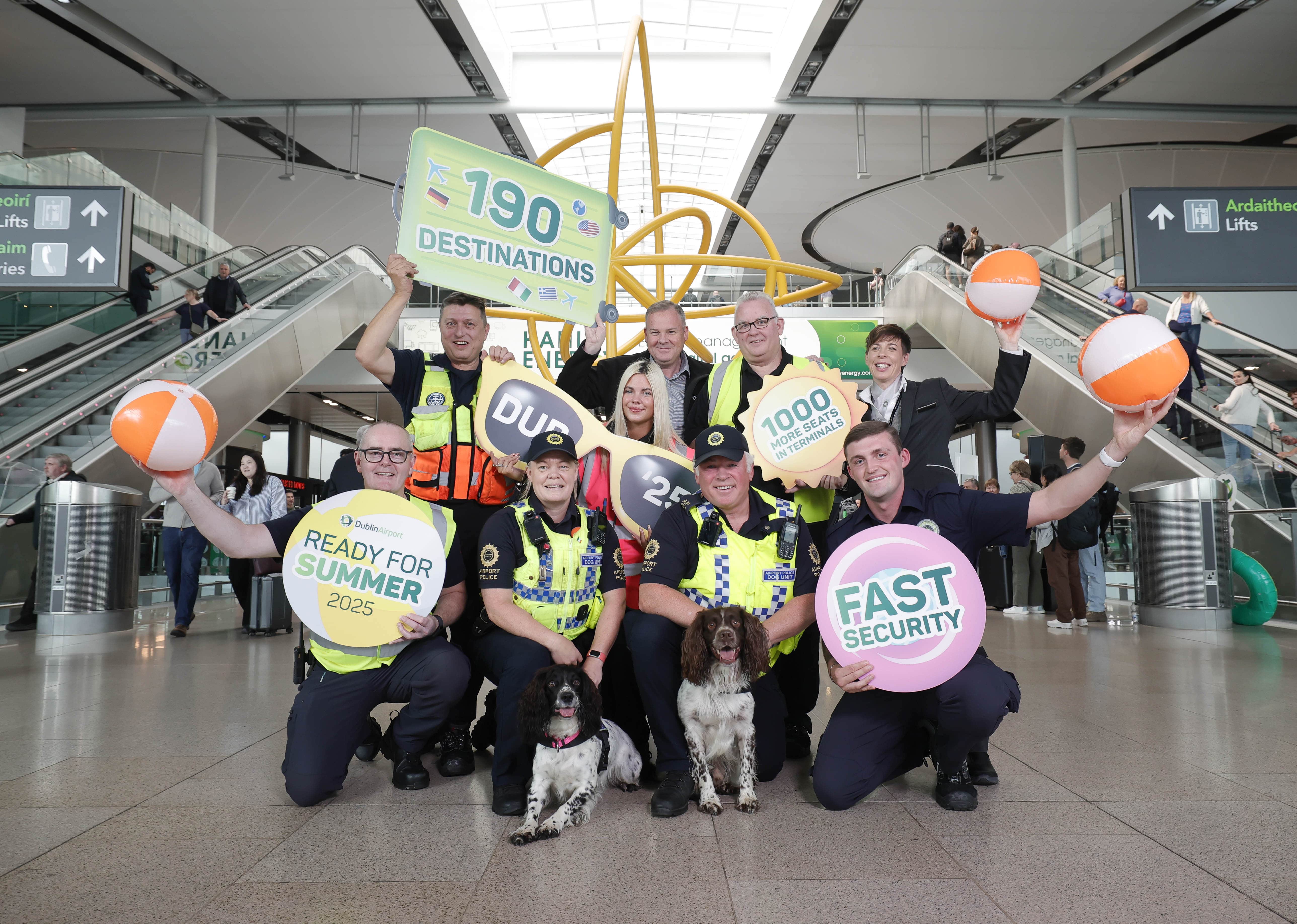 A group of people holding signs in an airport terminal