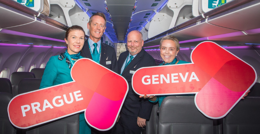 People on a plane holding signs
