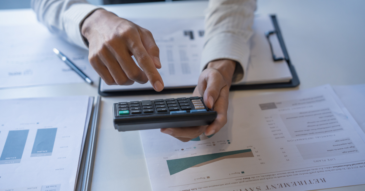A closeup of a person holding a calculator