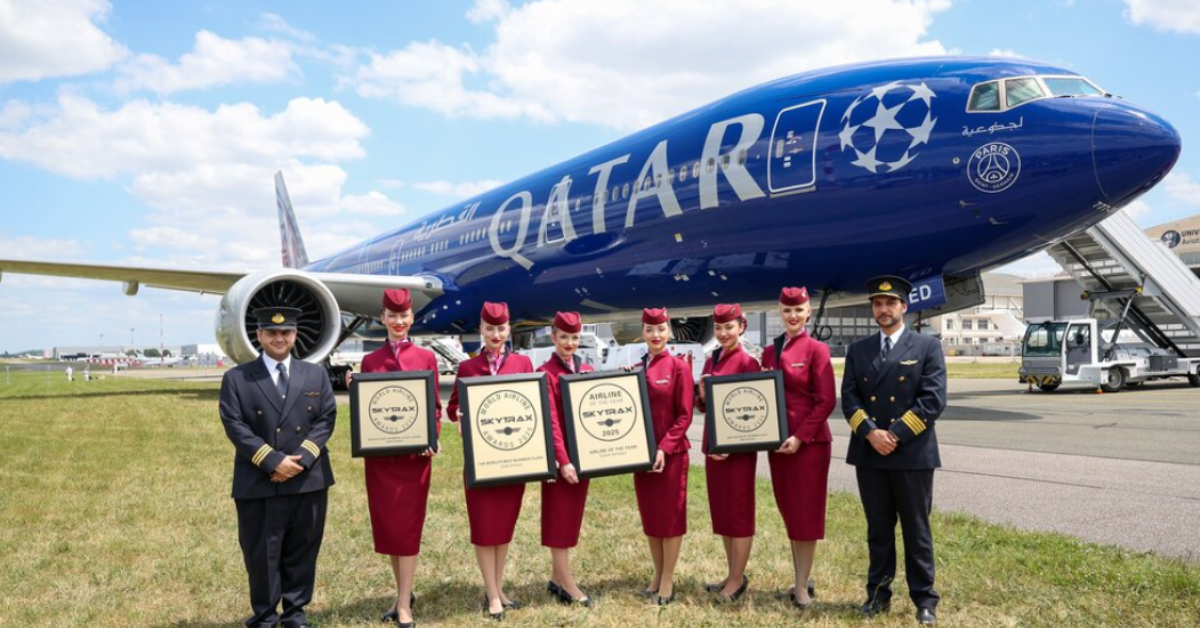 Pilots and air hostesses standing in front of a plane holding awards