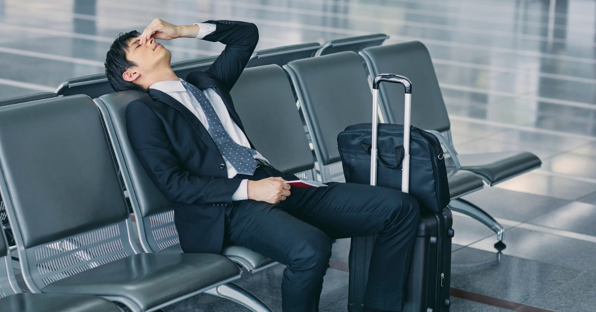 Man in a suit tired at the airport