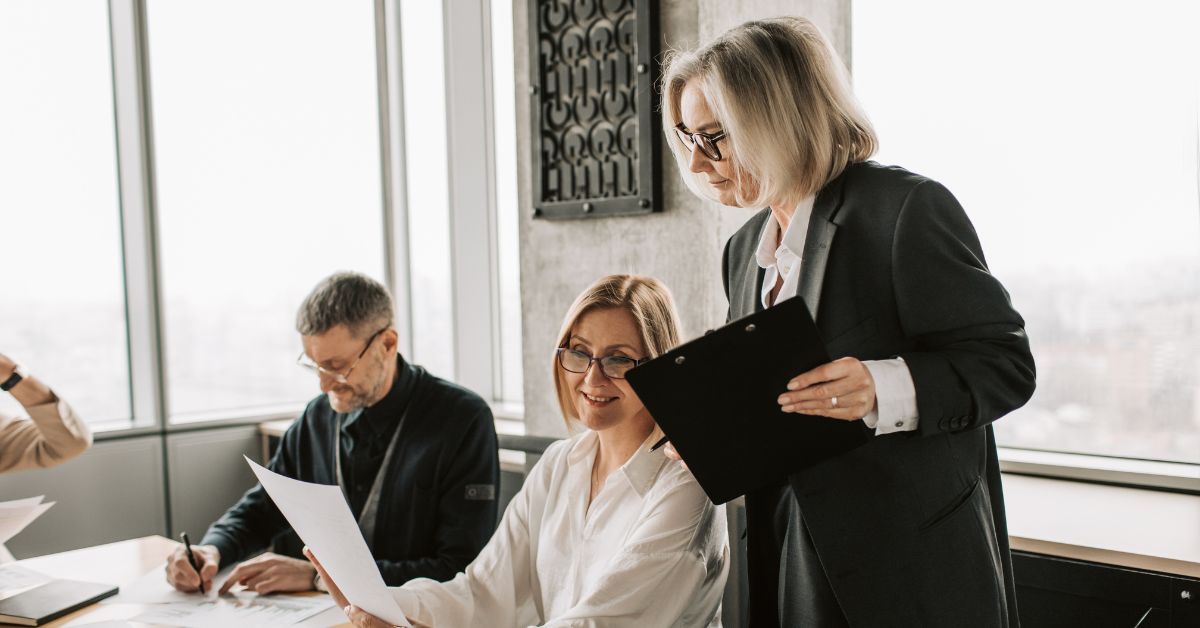 Two women and a man in an office