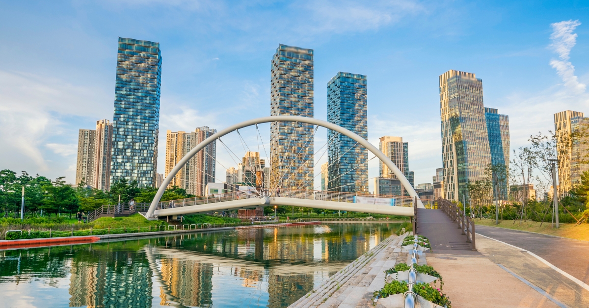 Tall buildings in a city and a pond