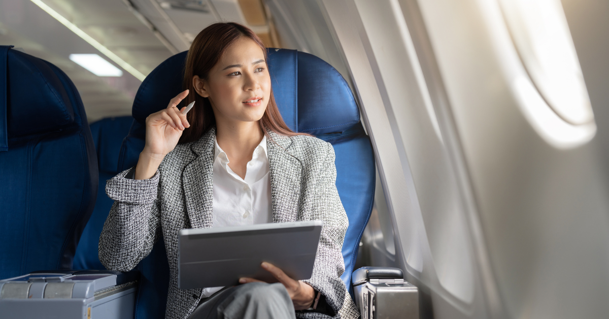 A woman in an airplane seat looking out the window