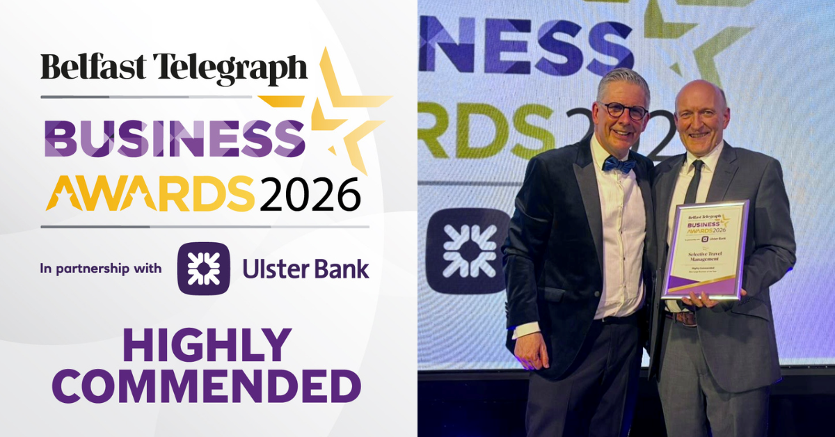 Two men smiling and holding an award