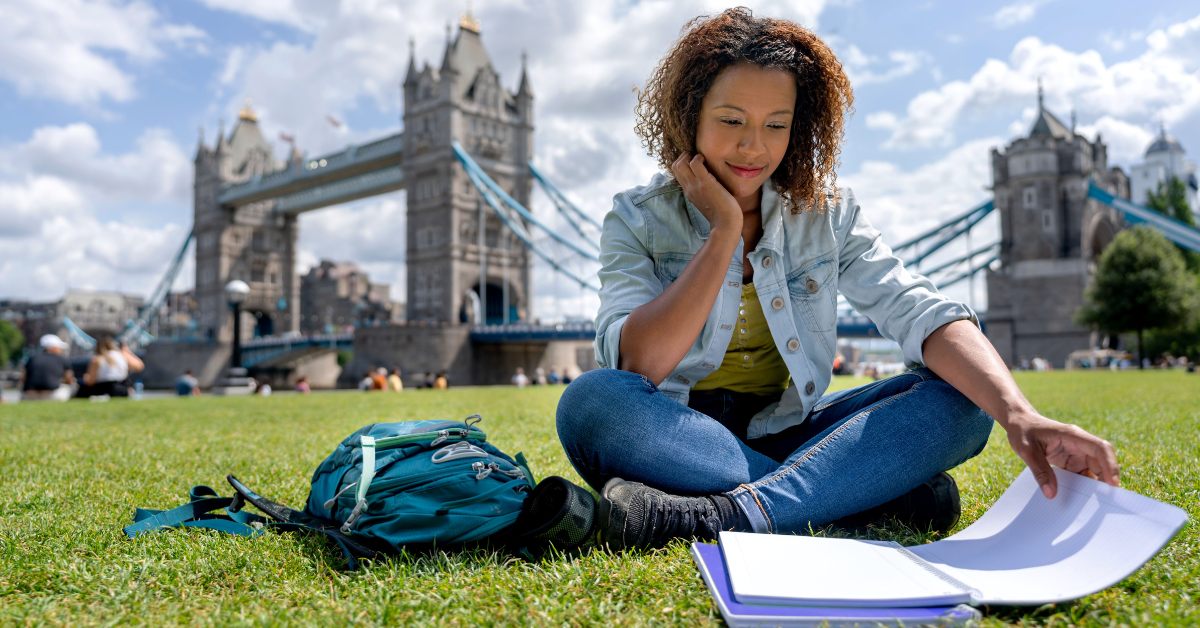 A student reading in front of Tower Bridge