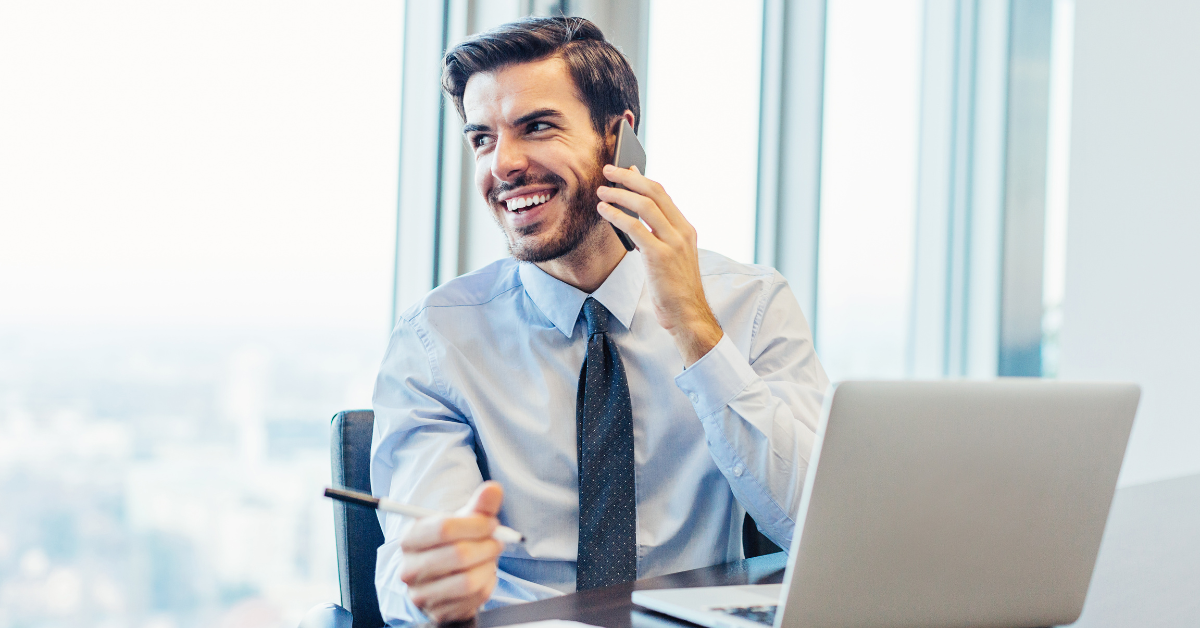 A man in a suit holding a mobile phone to his ear