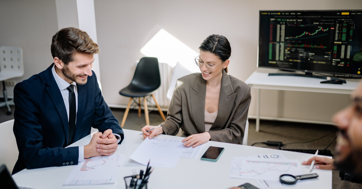 A group of people sitting at a meeting