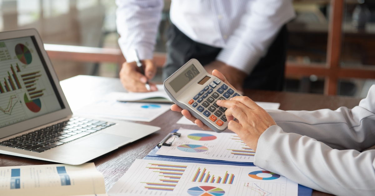 Man in an office using a calculator