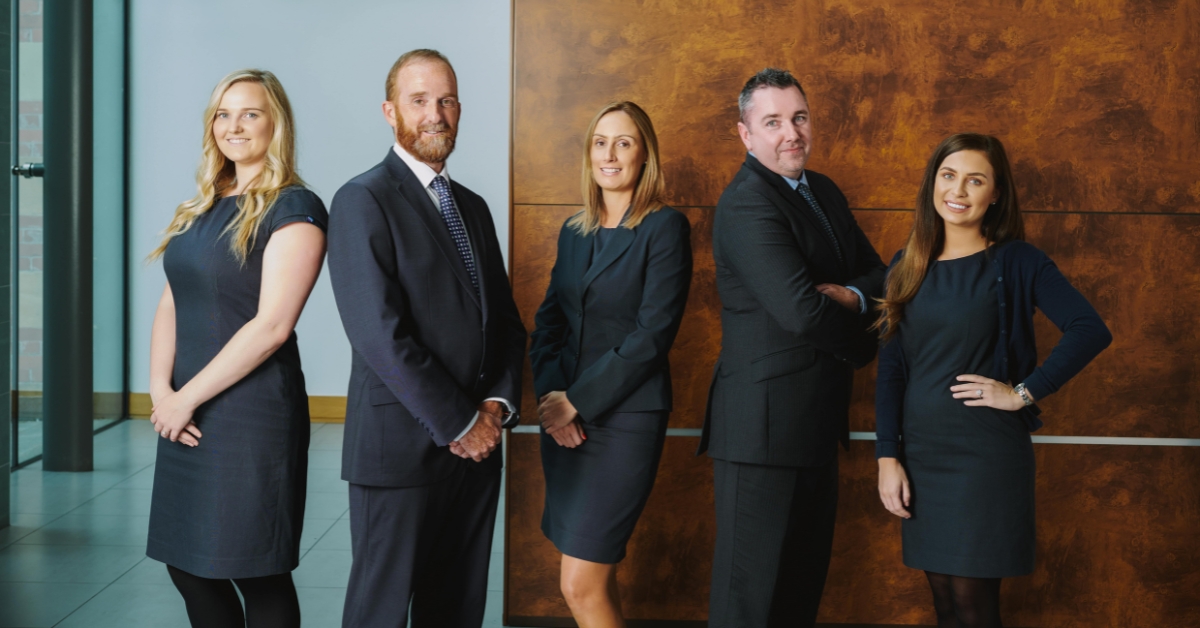 5 people posing in an office