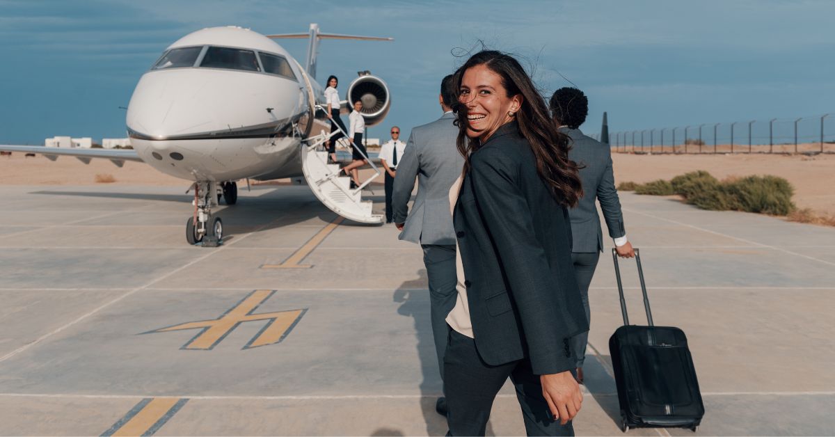 Woman smiling at in front of a plane