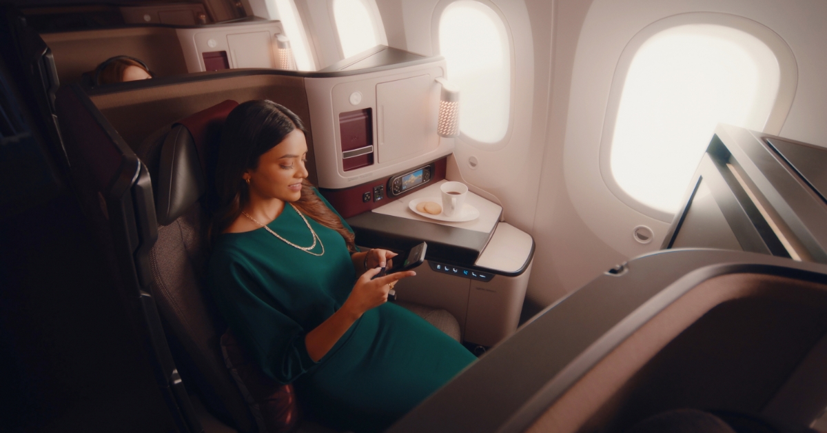 A woman using her phone on a plane