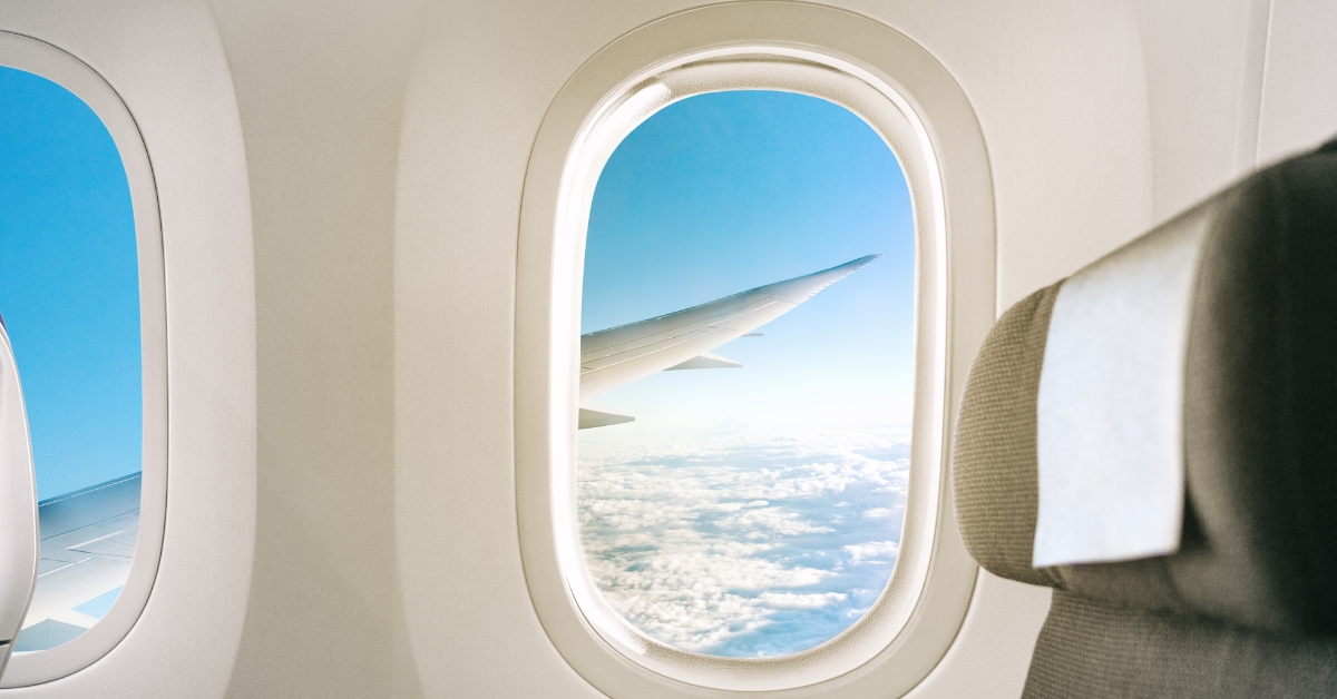 A view out the window of a plane in the sky