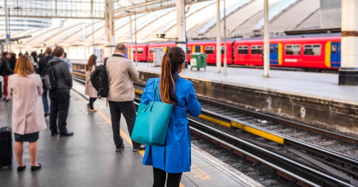 People standing at a rail platform